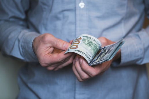 businessman-holding-money-in-his-hands-PQRBNZW